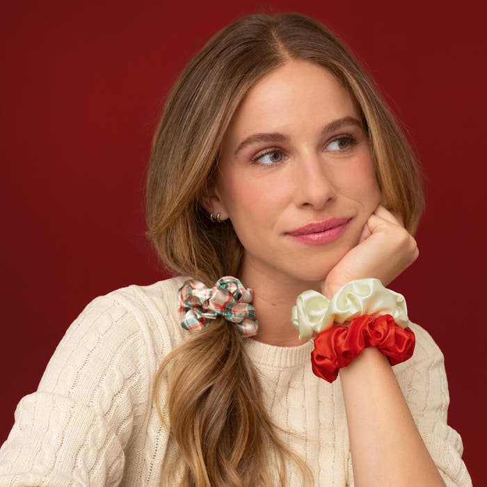 KITSCH Red & Gold Holiday Scrunchies 3pc Set — model with the plaid scrunchie in a side ponytail and two more worn on her wrist — Doubles as a cute wrist accessory when not in use — everyday holiday looks
