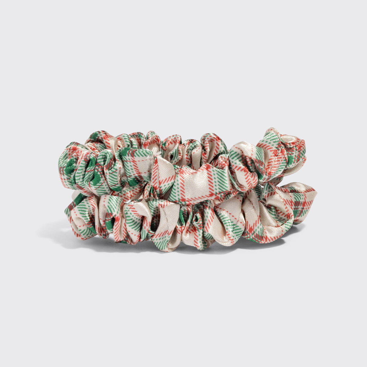 KITSCH Soft & Silky Hair 4pc Set — two ivory, red and green plaid satin scrunchies on a light gray backdrop — scrunchies provide gentle, snag-free hold for all hair types — the scrunchies' creaseless design helps protect hair from breakage