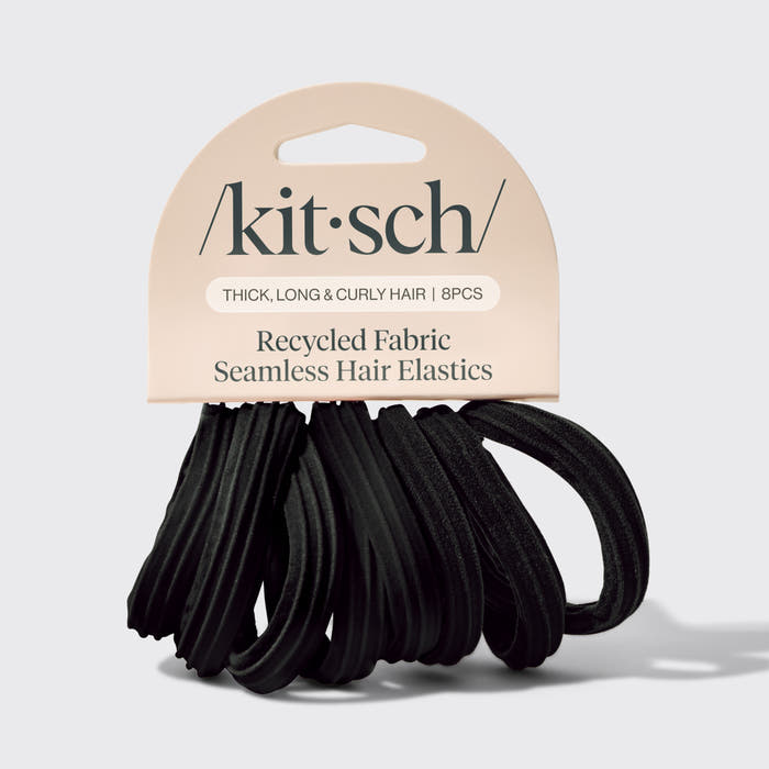 KitSch brand black seamless hair elastics made of recycled fabric, packaged on a beige cardboard header card against a light gray background.